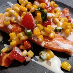 A picture of Pan-seared steelhead trout with corn salsa and lime cream.
