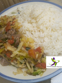 A picture of White rice and cabbage sauce.