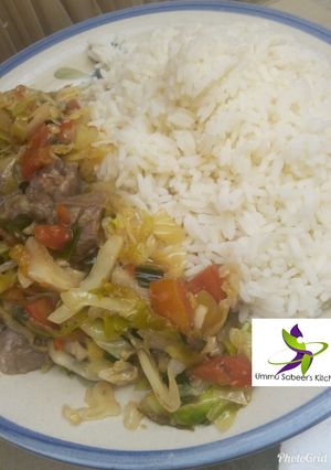 A picture of White rice and cabbage sauce.