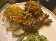 A picture of chicken drumsticks with oranges