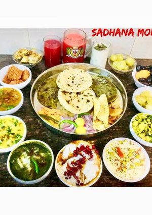 A picture of Punjabi Thali..Kadhi Pakoda,sarson ka saag,dahi Bhalla,carrots juice,lassi,gur.