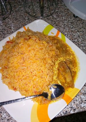 A picture of Jollof rice with chicken pepper sp.
