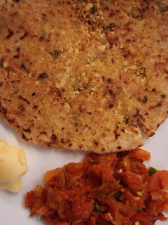 A picture of Gobhi Paratha with Tomato and Onion Bhurta.