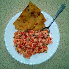 A picture of Scrambled eggs with chapati.