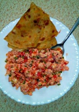 A picture of Scrambled eggs with chapati.