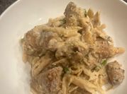 A picture of chicken alfredo with mushrooms