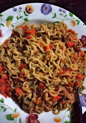 A picture of Noodles Garnished with Diced Carrot.