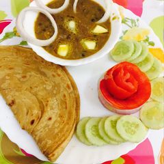 A picture of Dal makhani lachha paratha n salad.