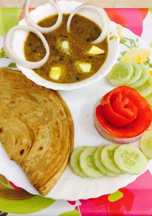 A picture of Dal makhani lachha paratha n salad.