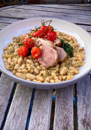 A picture of Zesty Pesto Beans with Dinosaur Kale and a rack of lamb.