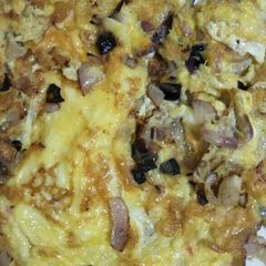 A picture of Fried eggs with onions.