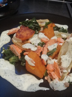A picture of Salmon, squash and kale with lemon and dill yoghurt sauce.