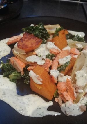 A picture of Salmon, squash and kale with lemon and dill yoghurt sauce.