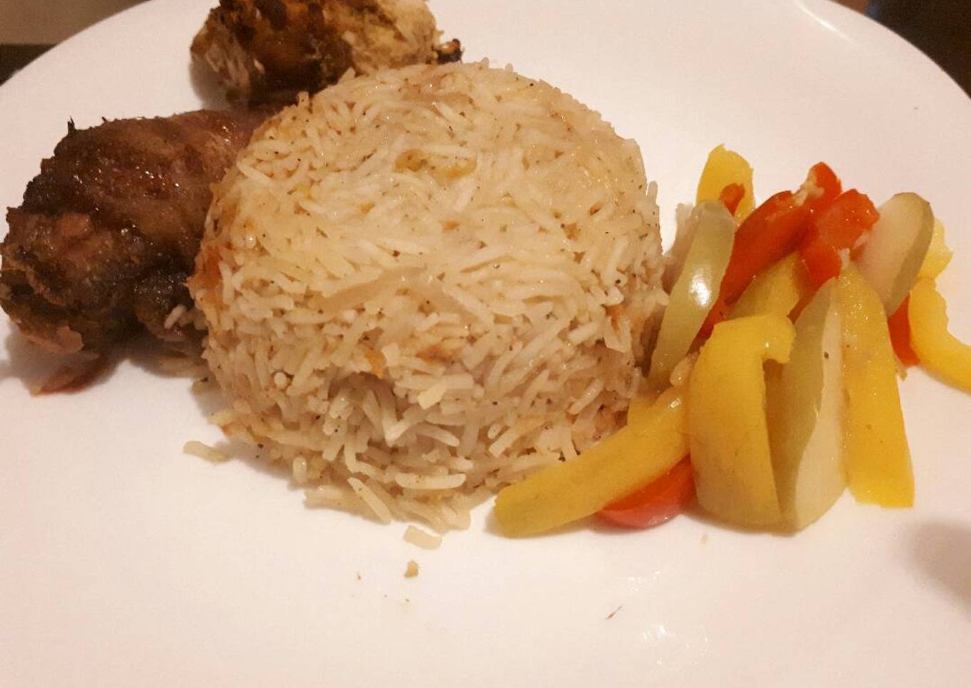 Jollof rice served with baked chicken