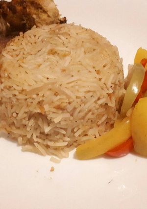 A picture of Jollof rice served with baked chicken.