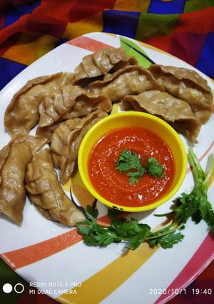A picture of Steamed Wheat Momos Stuffed with Paneer and Veggies.