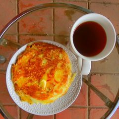 A picture of Pancake, butter and hot tea.