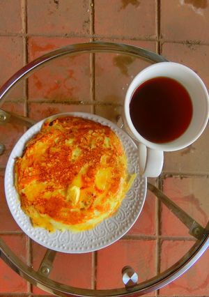 A picture of Pancake, butter and hot tea.