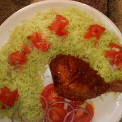 Colourd Rice with chicken stew and tomato's A picture of Colourd Rice with chicken stew and tomato's.