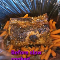 A picture of Honey garlic butter slow cooked pork roast with carrots.