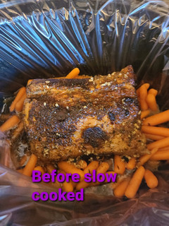 A picture of Honey garlic butter slow cooked pork roast with carrots.