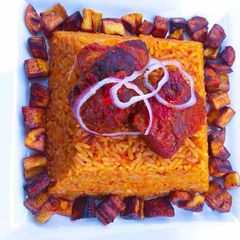A picture of Spicey jollof rice with diced plantain🤤.