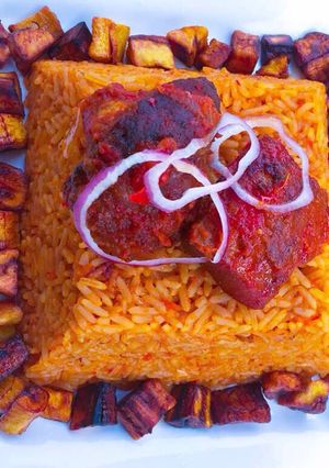 A picture of Spicey jollof rice with diced plantain🤤.