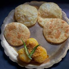 A picture of Bhetki Mach’r Kochuri o Doi Alu Dum Thakurbarir style.