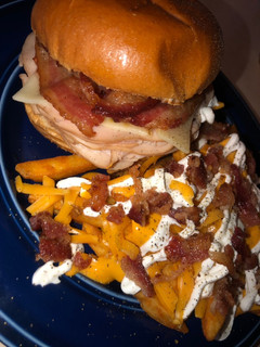 A picture of 1/2 lb Turkey pepper jack sandwich && loaded fries 🍟 🥓 🧀.