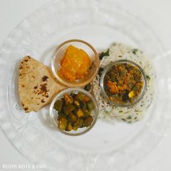 A picture of Haryali lunch with Gourd pickle.
