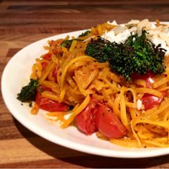 A picture of Butternut squash zoodles stir fry in spicy thai sauce, cherry tomatoes, broccolini, feta.