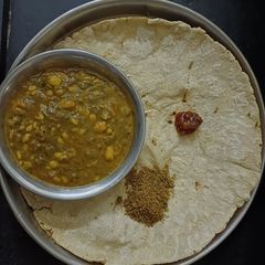 A picture of Rustic Bathua Saag with sorghum bhakri.