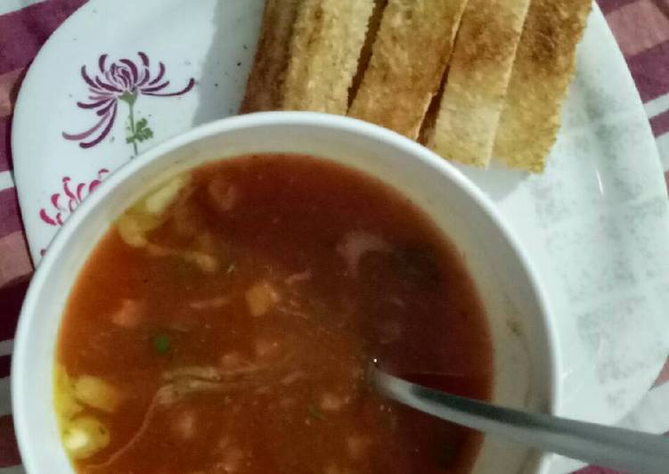 Tomato and carrot soup with bread sticks
