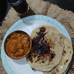 A picture of Paneer Butter Masala with Tandoori Naan.