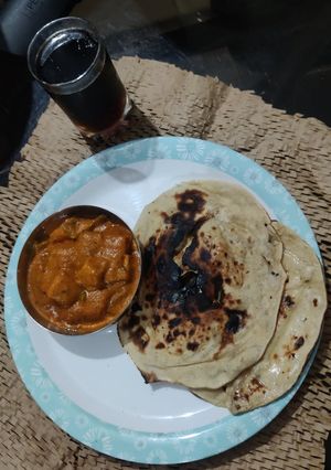 A picture of Paneer Butter Masala with Tandoori Naan.