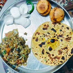 A picture of Sattu parantha with bharta.