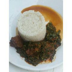 A picture of White rice with spinach stew.