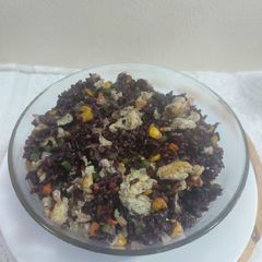 A picture of Black rice fried rice with sweet corn.