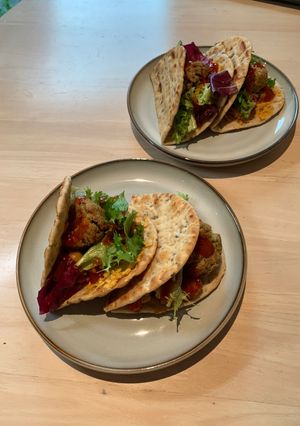 A picture of Flatbread with chickpeas, falafel & salad.