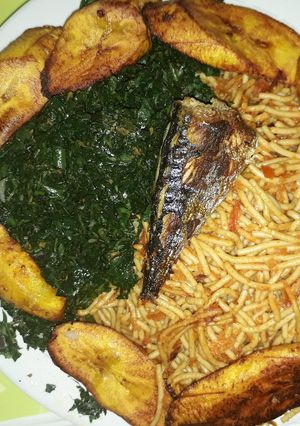 A picture of Spaghetti with fried plantain and vegetable.