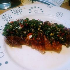 A picture of Sirloin Steak with Chimichurri dressing.