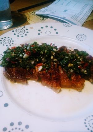 A picture of Sirloin Steak with Chimichurri dressing.