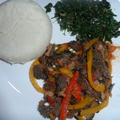 A picture of Matumbo (tripes) served with ugali and spinach.