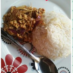 A picture of White rice with egg souce.
