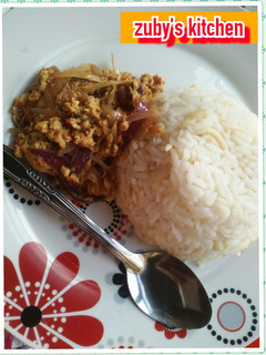A picture of White rice with egg souce.