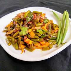 A picture of French Beans and Potato Fry with Onions.