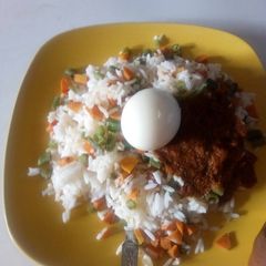A picture of Rice with tomatoe stew.