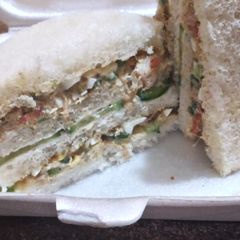 A picture of Round shape 3 layer chicken veggies sandwich.