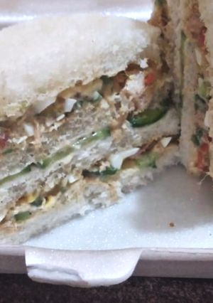 A picture of Round shape 3 layer chicken veggies sandwich.