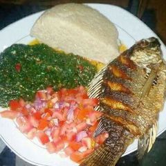 A picture of Fried Fish, Kales and Kachumbari With Ugali.